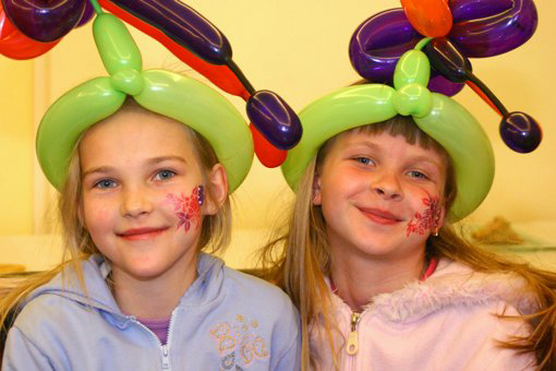 Kids with balloon hats at party